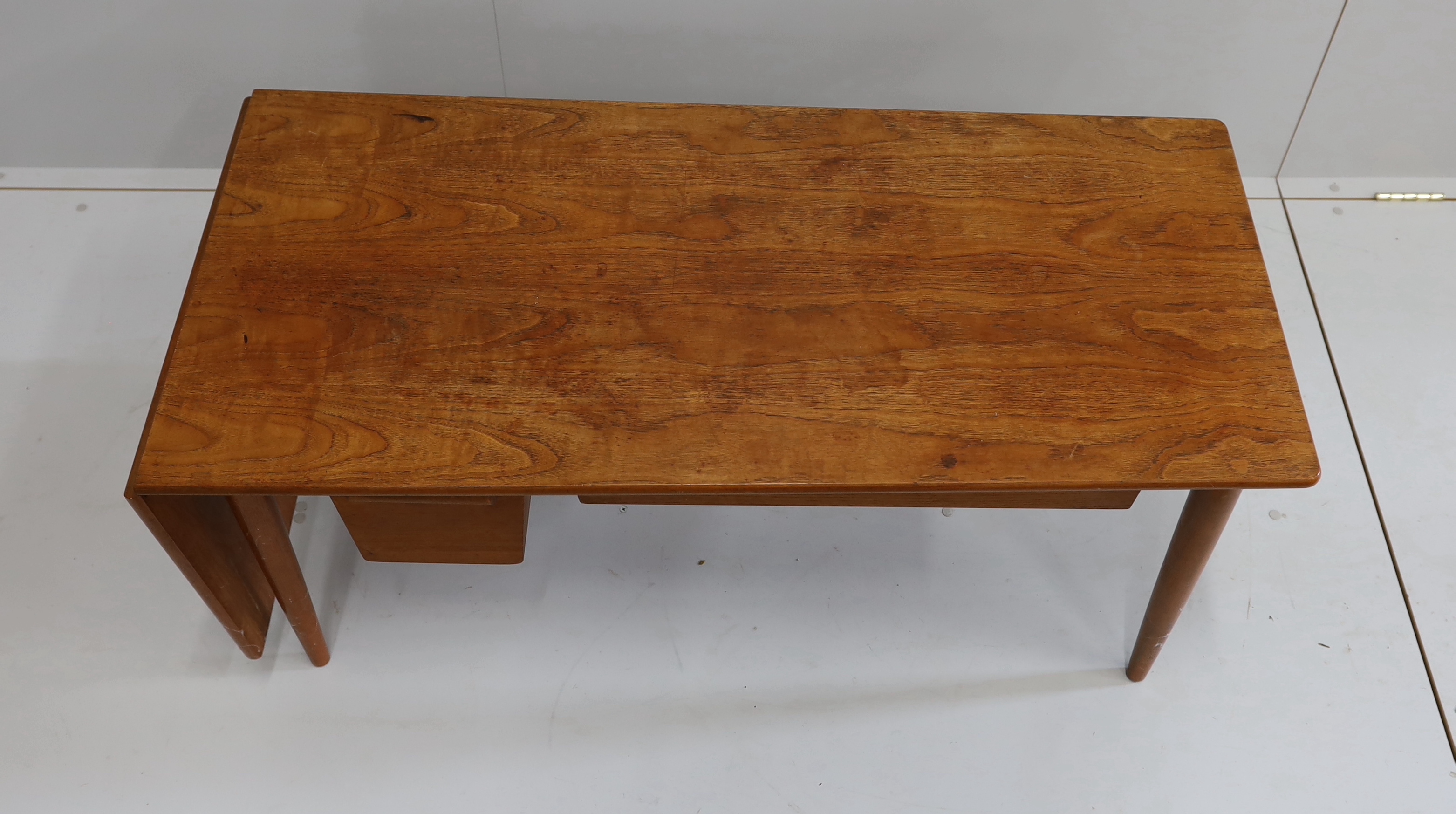 A mid century Danish design rectangular teak drop flap coffee / work table, width 117cm, depth 54cm, height 51cm (drawer runners in need of repair)